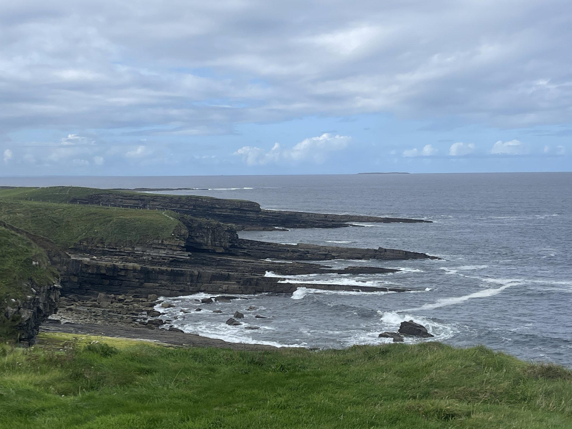 Layered sea cliffs meeting the North Atlantic along Ireland's Wild Atlantic Way